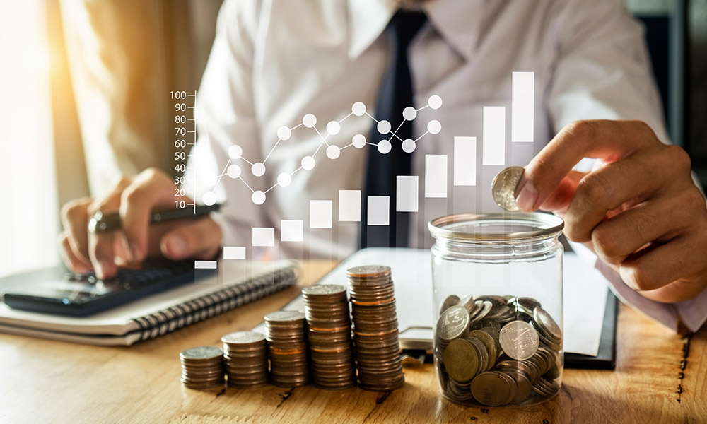 businessman holding coins putting in glass with using smartphone businessman holding coins putting in glass with using smartphone